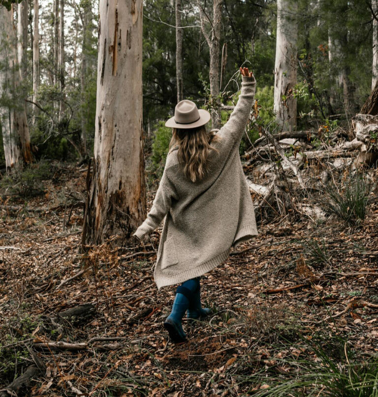 Happy-go-lucky Girl walking in woods